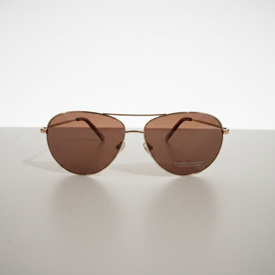 Draper James sunglasses classic aviator style with gold-toned metal frames.